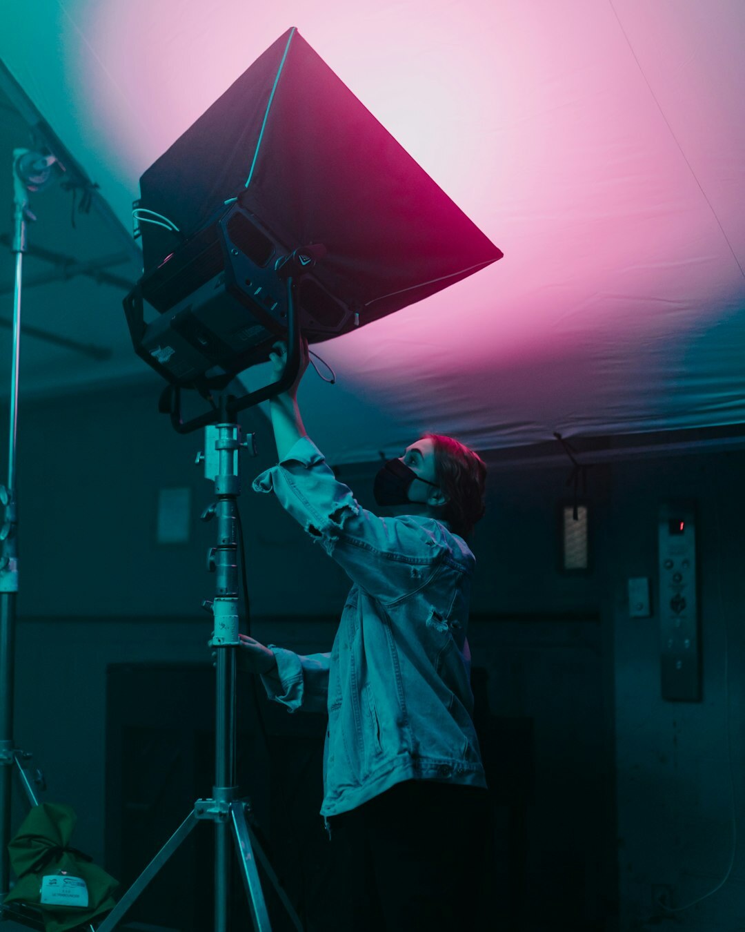 Professional television camera on a studio set with colorful stage lights