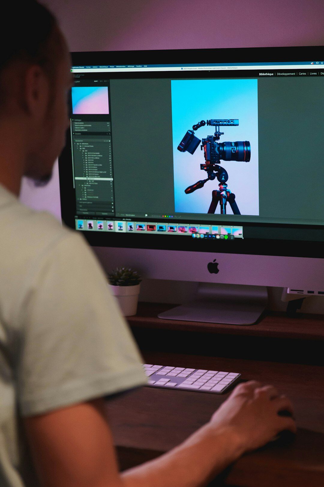 Video editor working on multi-camera footage on a professional monitor